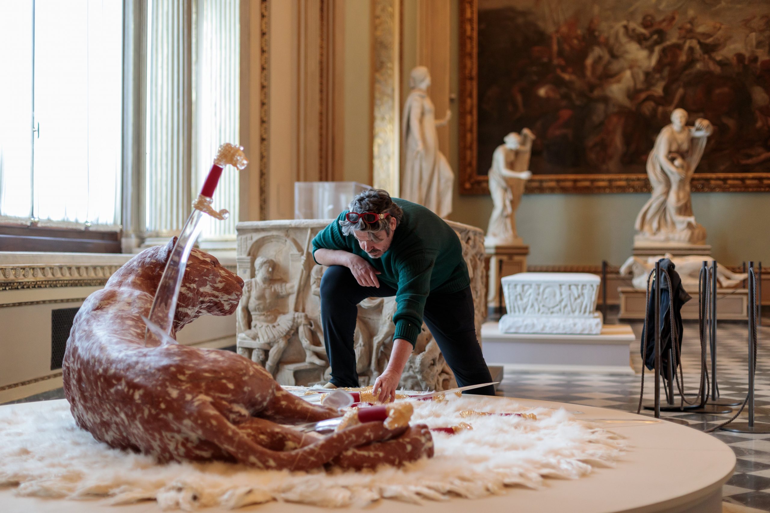 Koen Vanmechelen installing his artworks at the exhibition Seduzione, Gallerie degli Uffizi